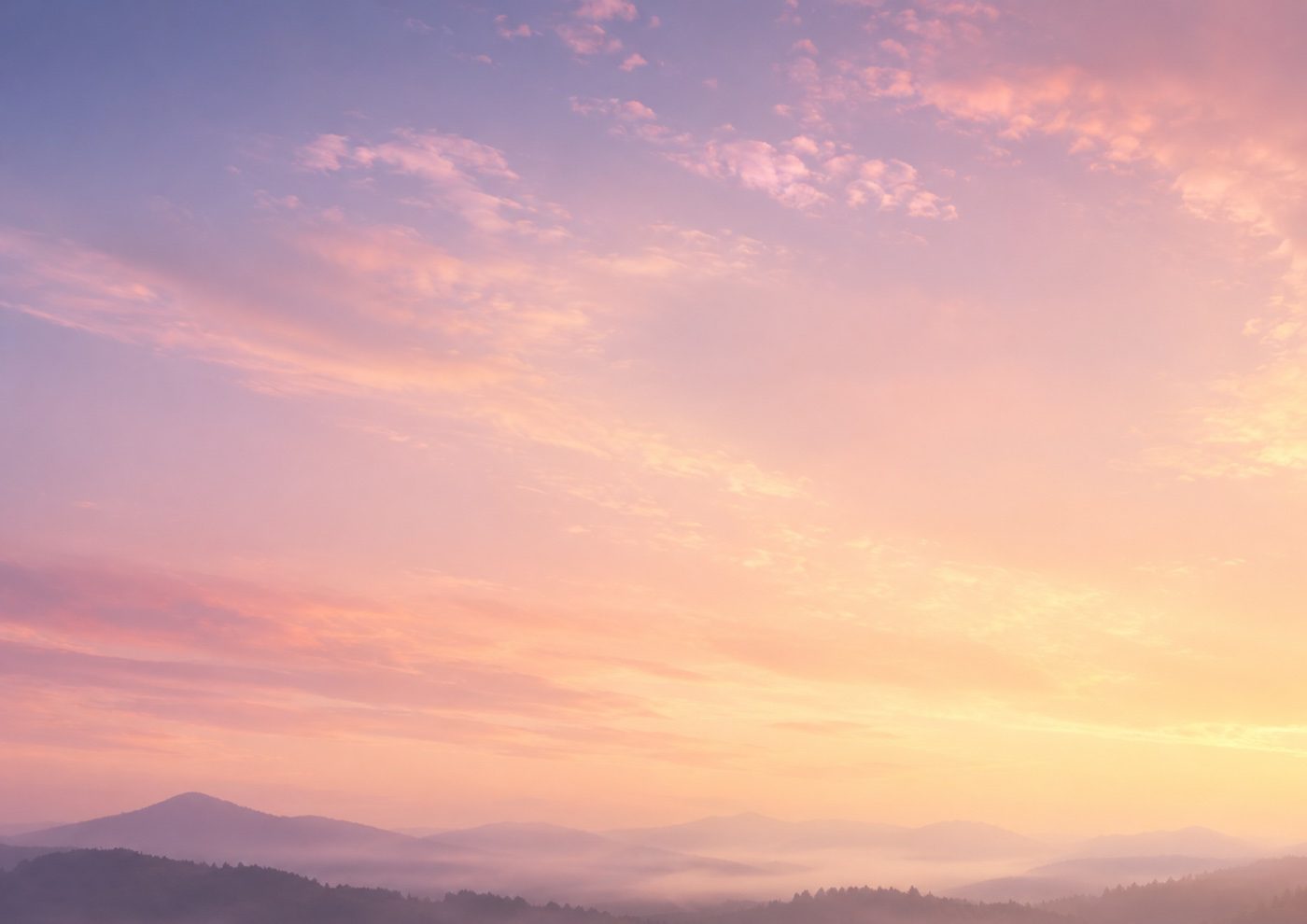 A hazy dawn sky over layered blue mountains — the Tired theme in Pause